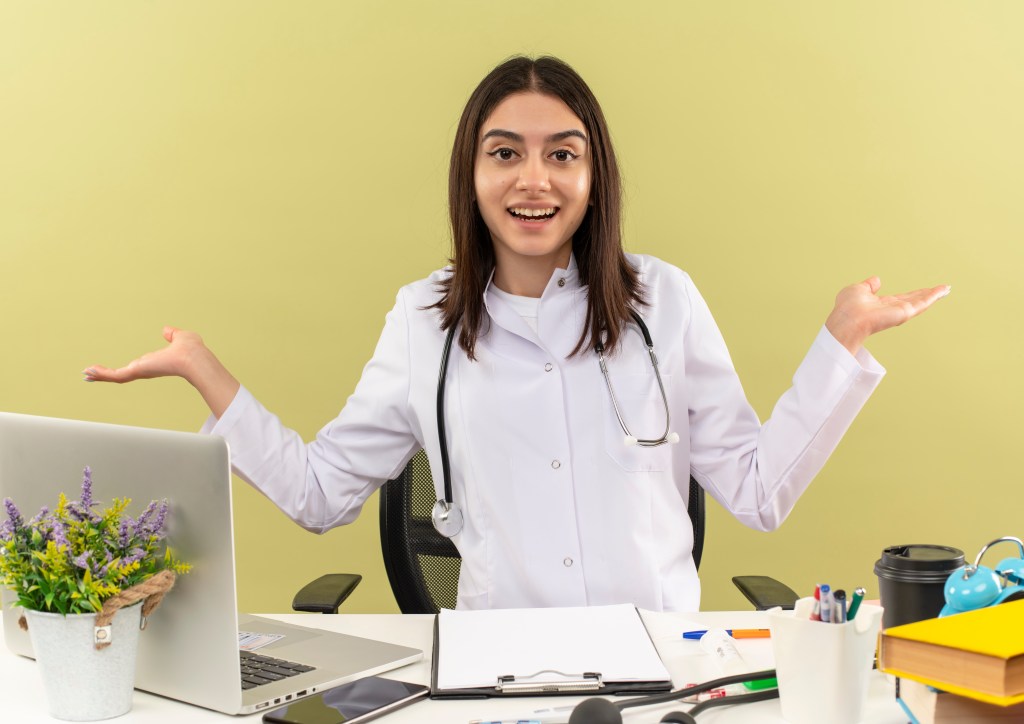 Confident doctor with independent healthcare practice website showcasing digital ownership